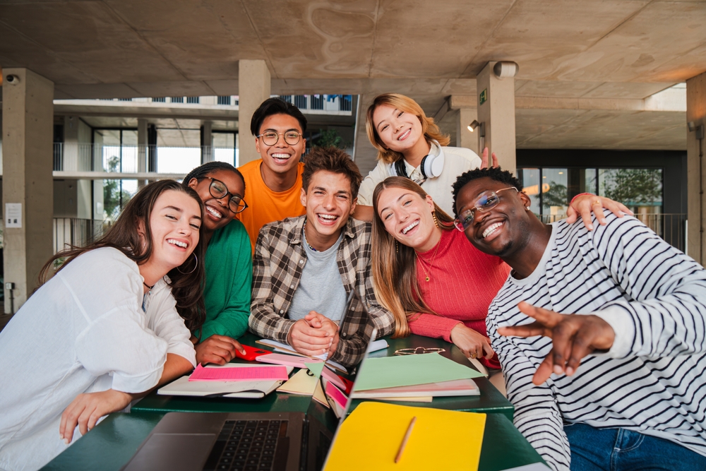 Happy,Young,University,Students,Smiling,And,Looking,At,Camera,Enjoying Happy Students working together